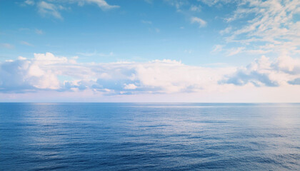 Obraz premium a beautiful blue sea with clouds. background, concept of calm and relaxation , high resolution
