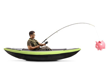 Side shot of a young man fishing from a canoe and catching a piggy bank © Ljupco Smokovski