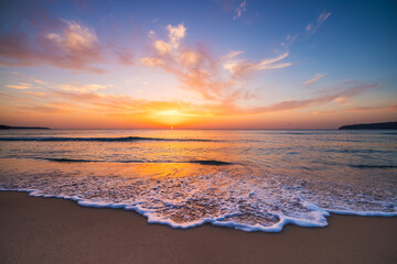 Beautiful sunrise over the sea sand and beach shore