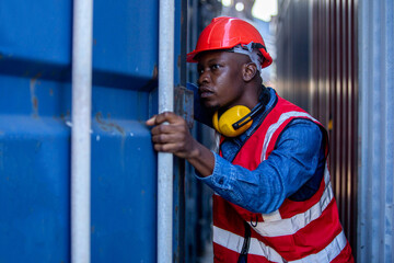 Male african american foreman opening door of container. engineering man checking containers loading. ​Area logistics import export and shipping.