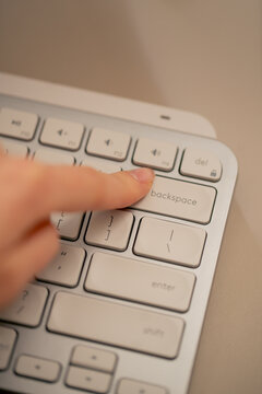 close-up female young hands pressing the backspace button on the keyboard office device nude manicure professional keyboard