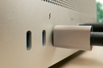 Close-up of USB ports in a computer with a metal case many different connectors inserted Type- wires connector designators