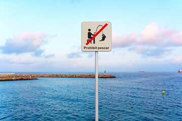 No Fishing Sign Beside Calm Water at Coastal Location