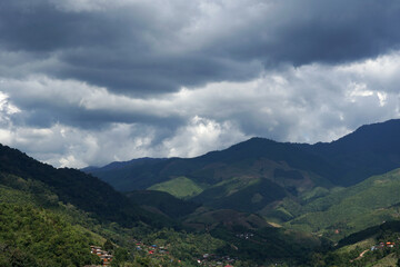 The perspective of the mountain range with nimbus clouds in the sky