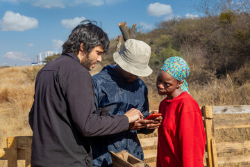 NGO charity workers educating african youth in mobile technologies, to startup their small business