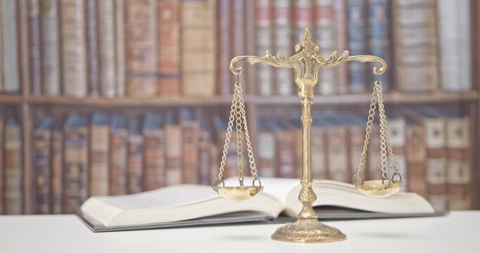 Legal office of lawyers, justice and law concept : Retro balance scale of justice on a desk in a courtroom, depicting giving fair and objective consideration to all evidence, without showing bias.