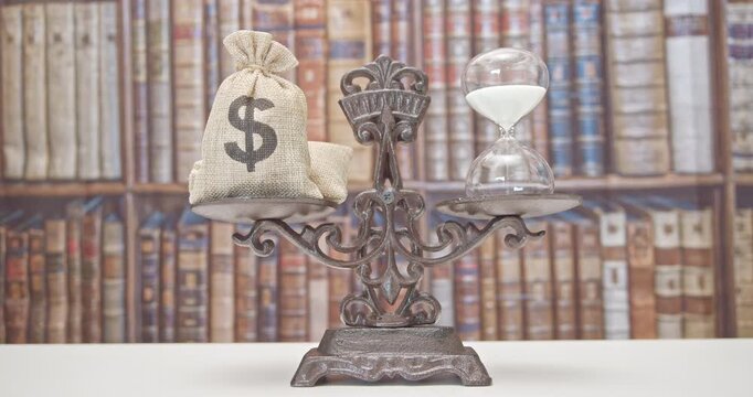 Time value of money, asset growth over time, financial concept : Dollar bags, sand clock or hourglass on a balance scale in equal position, depicts investment in long-term equity for more money growth