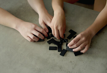 close up of hands playing dominoes