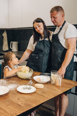 A Family Enjoys Baking Together in Their Cozy and Inviting Kitchen Space and Atmosphere. Happy family enjoys moments of cooking at home.