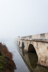 Fototapeta premium a historic bridge in the city, foggy weather, mystical atmosphere