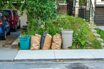 Yard waste at the curb waiting for city pickup room for text shot Toronto beaches in summer