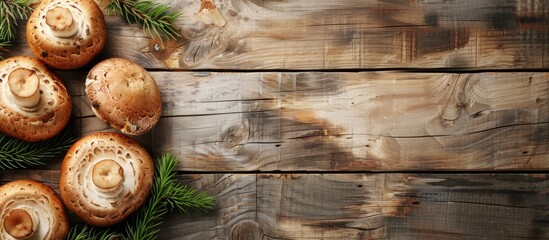 A wooden backdrop showcases fresh boletus mushrooms offering ample copy space for customization in the image