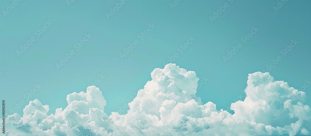 Poster sparse small clouds on a serene light blue sky with copy space image