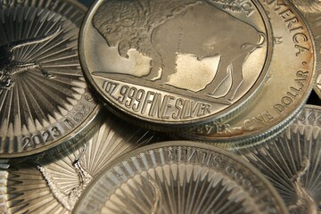 Investments in precious metals. Close-up of pure silver coins.