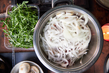 top view of a pan of marinated meat for kebabs with onions