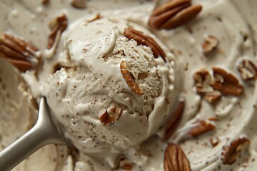 Close-up of Creamy Vanilla Ice Cream with Pecan Nuts and a Spoon.