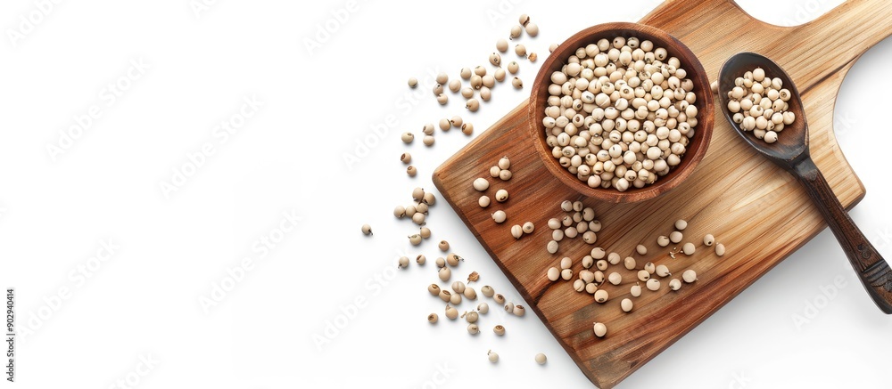 Poster a wooden board with a brown bowl filled with white pepper peas accompanied by a spoon set against a 