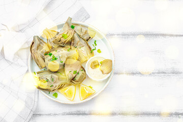 Traditional italian artichoke «alla romana», cooked carciofi vegetable. Olive oil, garlic, parsley