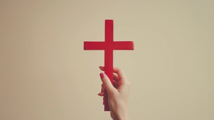 Obraz premium A hand holding red cross
