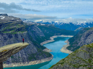 Fototapeta premium Breathtaking Hike at Trolltunga in Norway Surrounded by Majestic Fjords and Mountains
