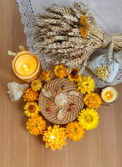 amulets, candles, flowers, witchcraft items, wheat ears and crystals on table. wiccan Witchcraft,...