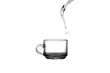Tea cup on a white background, Water falling into the glass, Pouring water onto a tea glass, Pouring water onto a coffee cup.