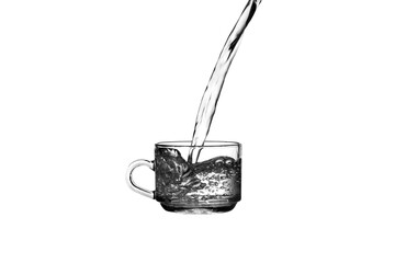 Water overflows from glass Water overflows from tea cup Pour water into a tea cup Tea cup on a white background.