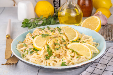 Homemade lemon pepper pasta, al limone spaghetti with creamy sauce with with lemon and pepper, copy space