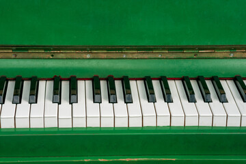 A green piano with white keys