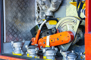 A fire truck with a large orange tool on the front