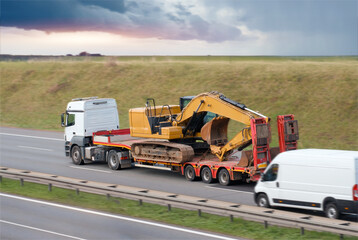 Semi-Truck Transporting Large Excavator on Flatbed Trailer