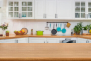 Kitchen wood table top for product display with blurred modern interior. Wooden tabletop over defocused kitchen background. kitchen furniture and desk space. product promotion in the kitchen