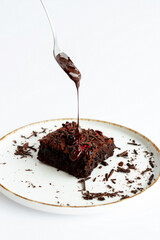 Indulge in a Delicious Chocolate Brownie topped with a Drizzling Sauce for extra flavor