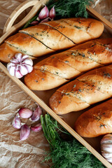 Freshly baked garlic bread rolls, elegantly garnished with herbs and garlic