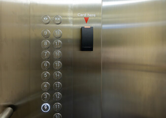 A silver elevator with a card reader on the wall © Rattanachat