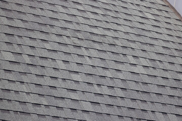 A roof with a grey shingled covering