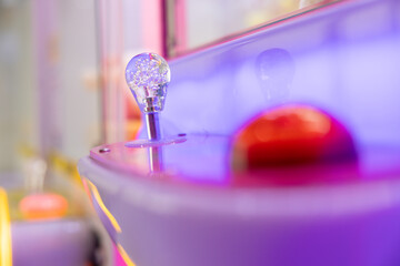 A claw machine controller and button. Claw Machines Toy Arcade game. doll picker. © Rattanachat