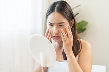 Anti wrinkle aging, worry puberty asian young woman, stressed looking in mirror, allergy presenting...