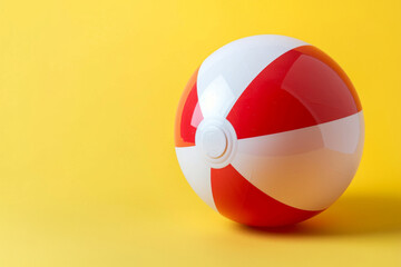 Naklejka premium Red and White Beach Ball on Yellow Background