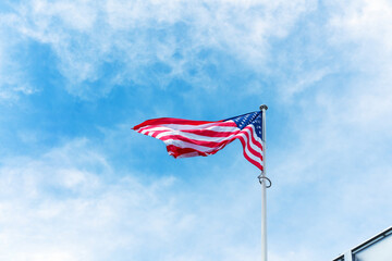 Low-angle view of the national flag of the United States of America waving on a flagpole