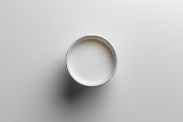 Minimalist White Bowl of Milk on a Smooth Surface