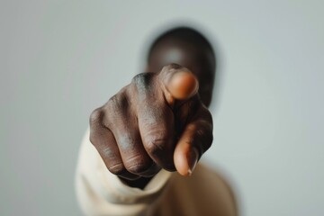 Close-Up of Dark Skinned Hand Pointing Forward for Leadership and Direction Concepts