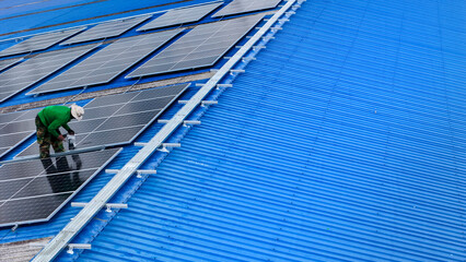 top aerial of engineer men inspects construction of solar cell panel or photovoltaic cell at roof...