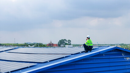engineer man inspects construction of solar cell panel or photovoltaic cell by electronic device. Industrial Renewable energy of green power. factory worker working on tower roof.