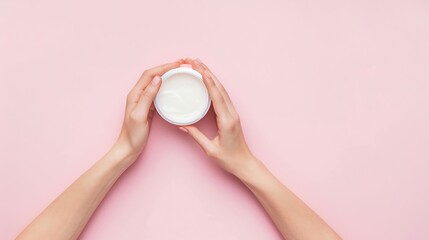 Cropped top view of female hands holding container with cream in hands Using cosmetics product isolated pastel pink background Concept of body and skin care spa dermatology treatments  : Generative AI