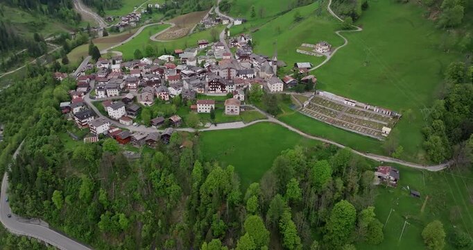 Aerial view Rocca Pietore italy cityscape. Small tourist town on mountain slopes in tourist dolomite alps, houses street for travel. High quality 4k footage