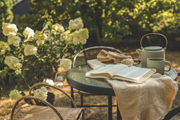 Bible on table in garden, morning prayer and worship