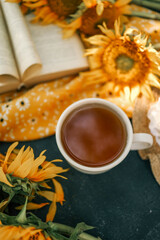A cup of tea, a book and sunflowers, a summer mood