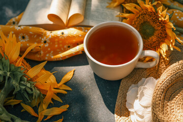 A cup of tea, a book and sunflowers, a summer mood