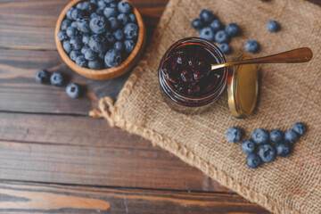 Delicious organic blueberry jam on dark background